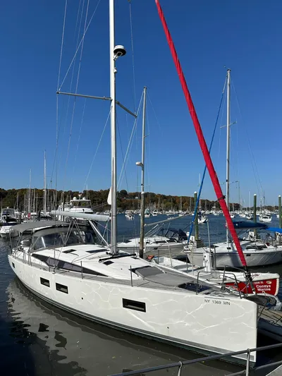  Yacht Photos Pics 2018 Jeanneau 51 sailboat docked in a marina under clear blue skies.