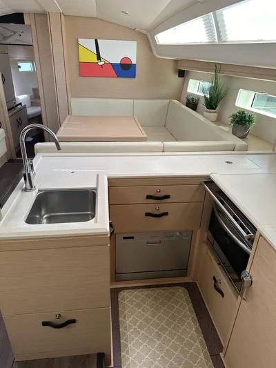  Yacht Photos Pics Modern Jeanneau 51 yacht interior with sleek kitchen, cozy seating, and contemporary decor.