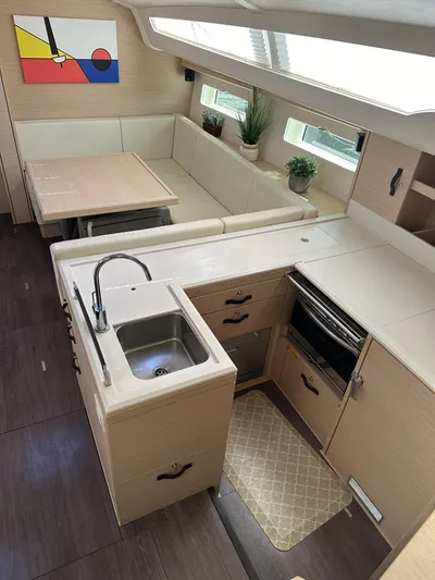  Yacht Photos Pics Modern Jeanneau 51 yacht interior with kitchen and dining area, featuring sleek design and natural light.