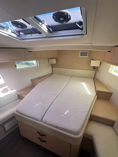  Yacht Photos Pics Interior of 2018 Jeanneau 51 yacht with spacious bed and skylight.
