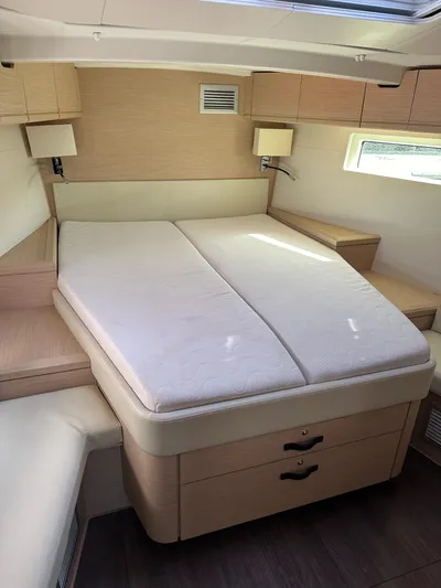  Yacht Photos Pics Luxurious cabin interior of 2018 Jeanneau 51 yacht with comfortable double bed.