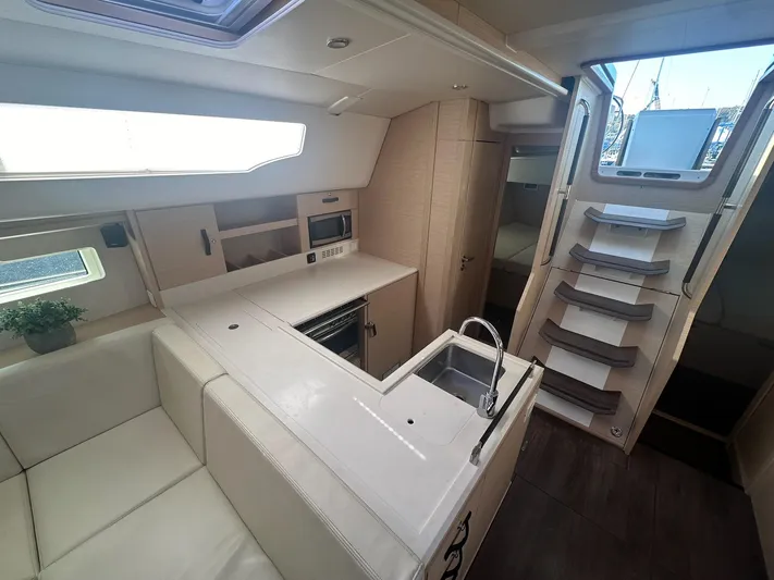  Yacht Photos Pics Luxurious interior of a 2018 Jeanneau 51 yacht with modern kitchen and seating area.