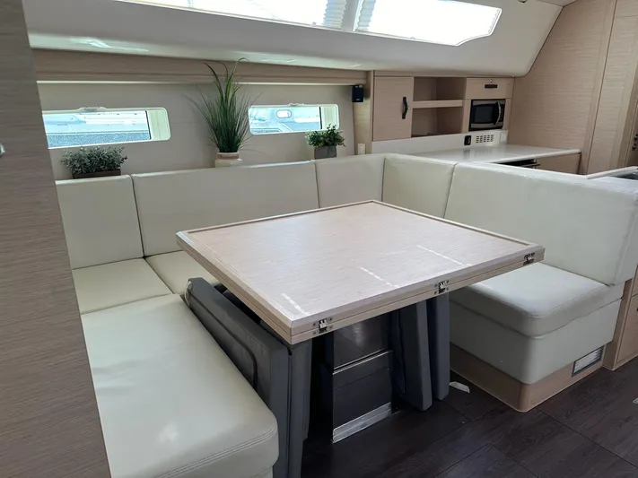  Yacht Photos Pics Interior of 2018 Jeanneau 51 yacht with modern dining area and light wood finishes.