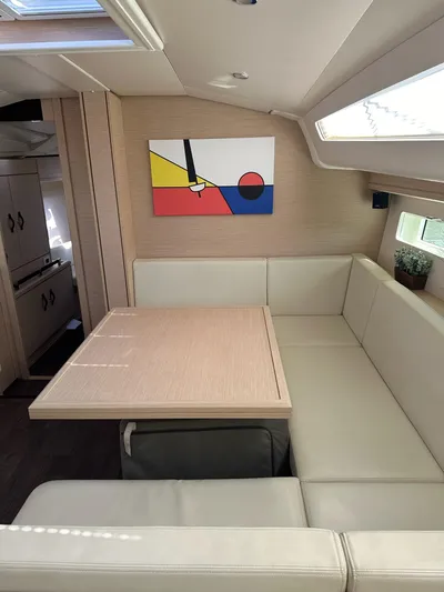  Yacht Photos Pics Interior of 2018 Jeanneau 51 yacht with modern art and beige seating.