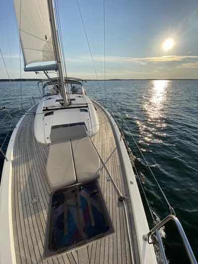  Yacht Photos Pics 2018 Jeanneau 51 sailboat on calm water at sunset.