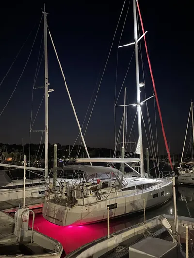  Yacht Photos Pics 2018 Jeanneau 51 yacht docked at night with illuminated red underglow.