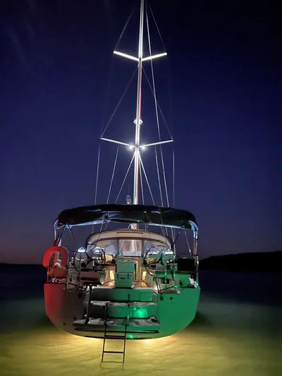  Yacht Photos Pics 2018 Jeanneau 51 yacht illuminated at night on calm waters.