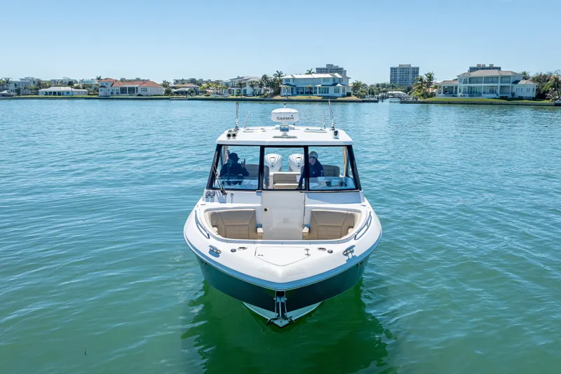 Kashmir Yacht Photos Pics 2019 Everglades 340 Dual Console boat on calm water near luxury waterfront homes.