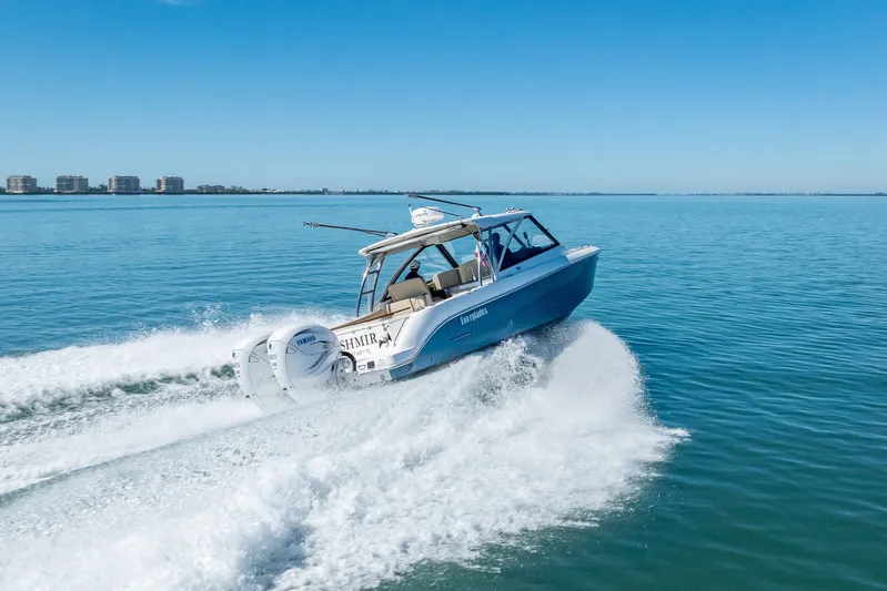 Kashmir Yacht Photos Pics 2019 Everglades 340 Dual Console boat cruising on clear blue water.