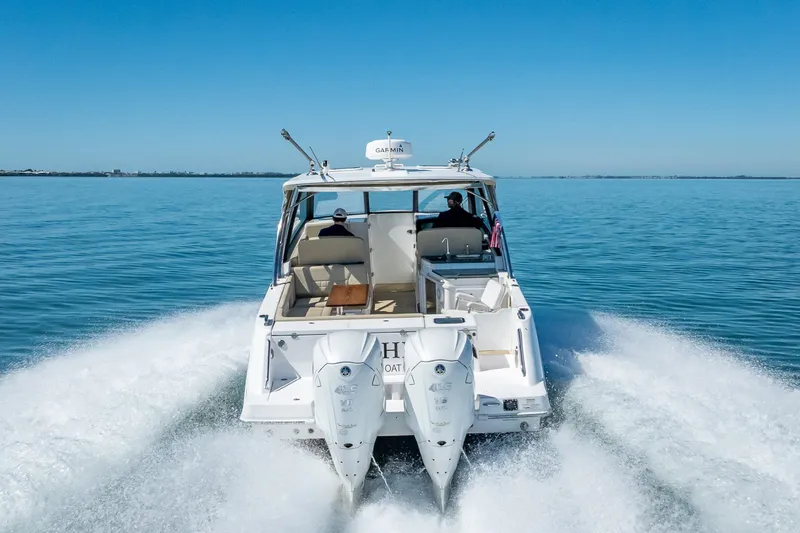 Kashmir Yacht Photos Pics 2019 Everglades 340 Dual Console boat cruising on open water, rear view.
