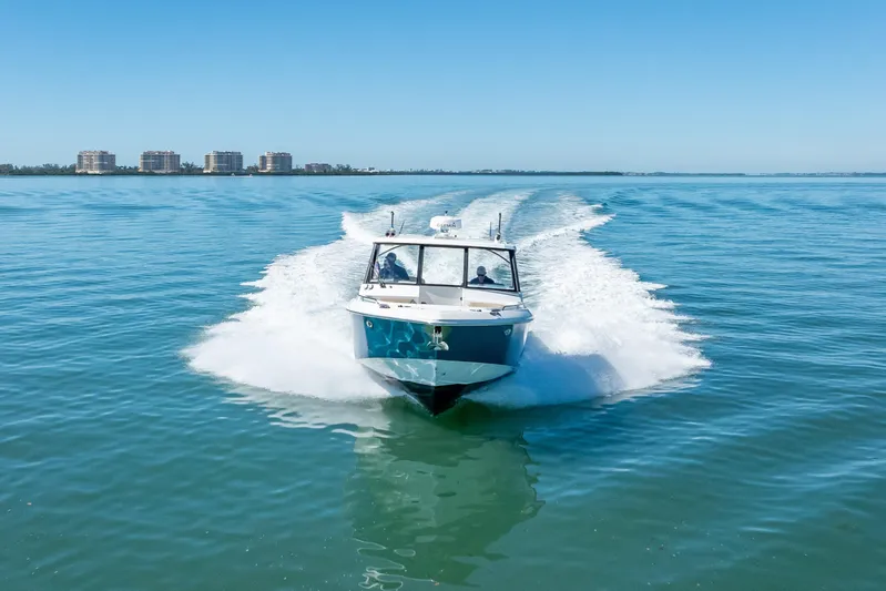 Kashmir Yacht Photos Pics 2019 Everglades 340 Dual Console boat cruising on clear blue water.
