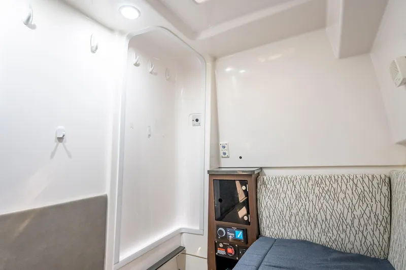 Kashmir Yacht Photos Pics Interior cabin of 2019 Everglades 340 Dual Console boat, featuring seating and storage.