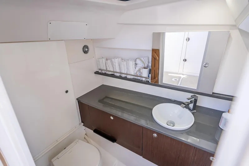 Kashmir Yacht Photos Pics Luxurious bathroom interior of 2019 Everglades 340 Dual Console boat, featuring modern sink and mirror.
