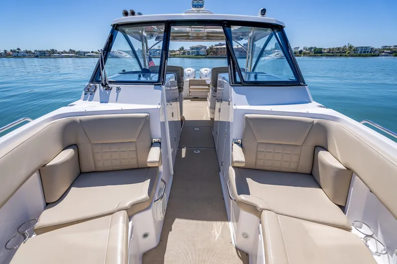 Kashmir Yacht Photos Pics 2019 Everglades 340 Dual Console boat interior with beige seating on calm water.