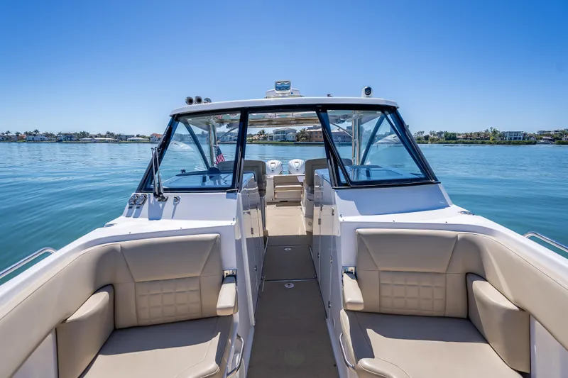 Kashmir Yacht Photos Pics 2019 Everglades 340 Dual Console boat on calm water, featuring spacious seating and clear skies.
