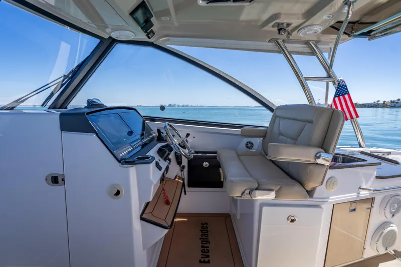 Kashmir Yacht Photos Pics 2019 Everglades 340 Dual Console boat interior with helm and seating, overlooking calm waters.