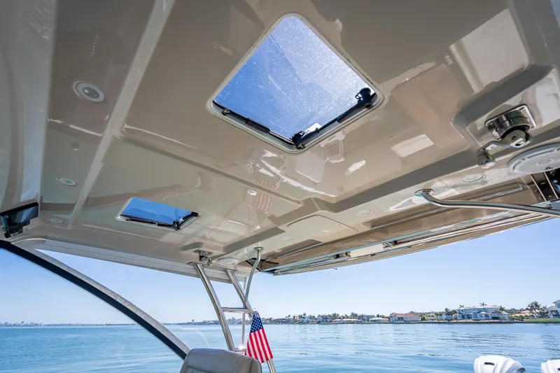 Kashmir Yacht Photos Pics Interior view of 2019 Everglades 340 Dual Console boat with open sunroof and ocean backdrop.