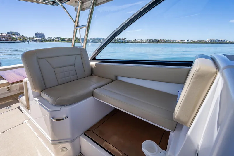 Kashmir Yacht Photos Pics 2019 Everglades 340 Dual Console boat interior with beige seating and waterfront view.