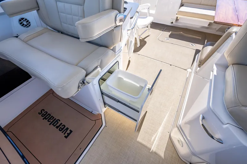 Kashmir Yacht Photos Pics 2019 Everglades 340 Dual Console interior with seating and storage drawer open.