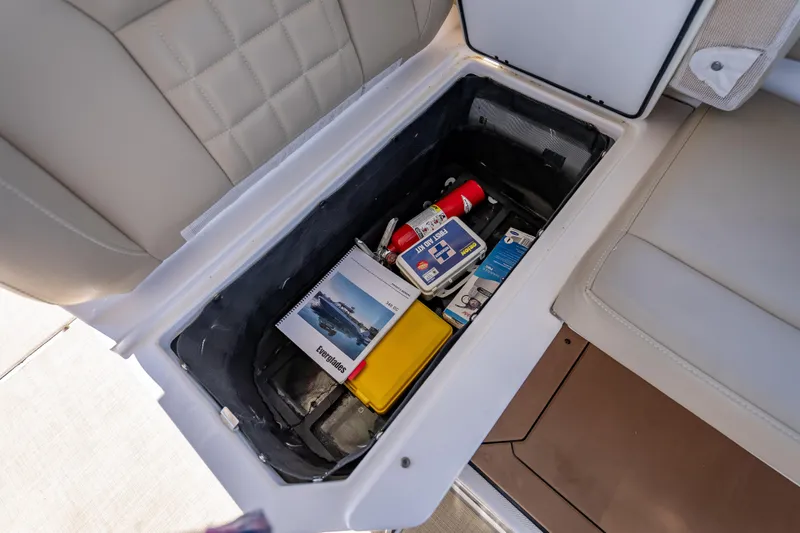 Kashmir Yacht Photos Pics Storage compartment in 2019 Everglades 340 Dual Console boat with safety equipment and manuals.