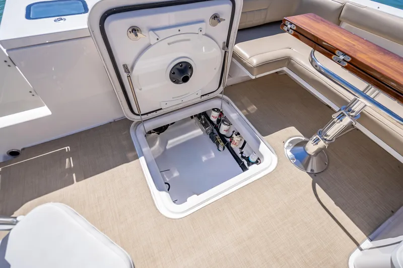 Kashmir Yacht Photos Pics Open hatch on 2019 Everglades 340 Dual Console boat, revealing storage compartment.