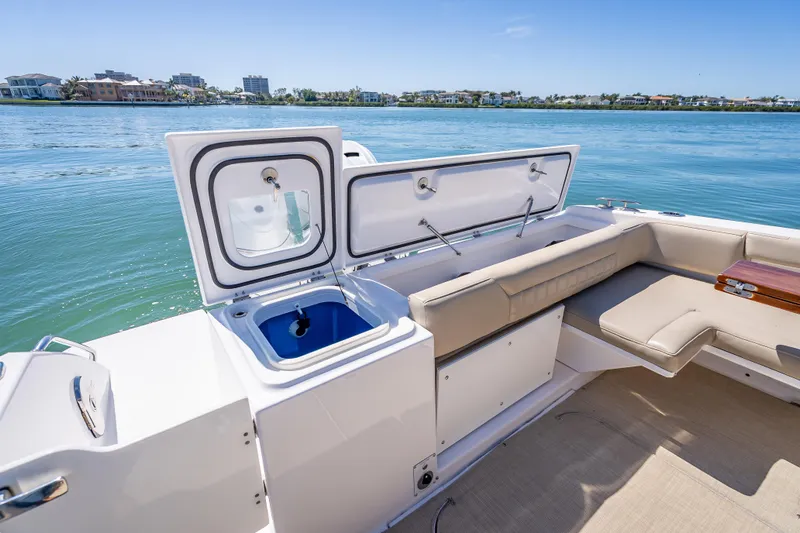Kashmir Yacht Photos Pics 2019 Everglades 340 Dual Console boat interior with open storage and seating, near waterfront homes.