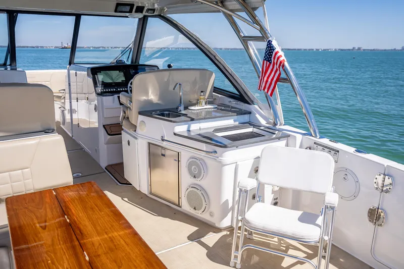 Kashmir Yacht Photos Pics 2019 Everglades 340 Dual Console boat interior with seating and kitchenette on open water.