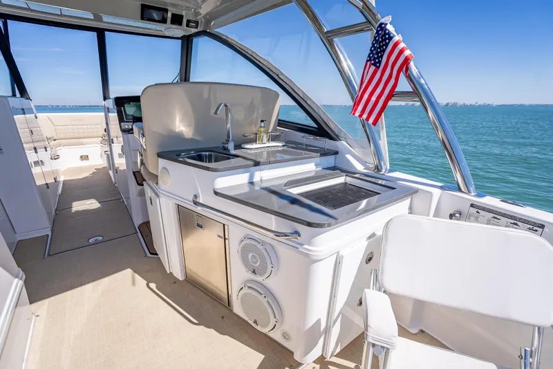 Kashmir Yacht Photos Pics 2019 Everglades 340 Dual Console boat interior with kitchenette and American flag.