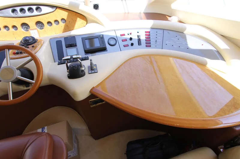 Sevrik Yacht Photos Pics Cockpit of 2004 Azimut 62 yacht with steering wheel and control panel.