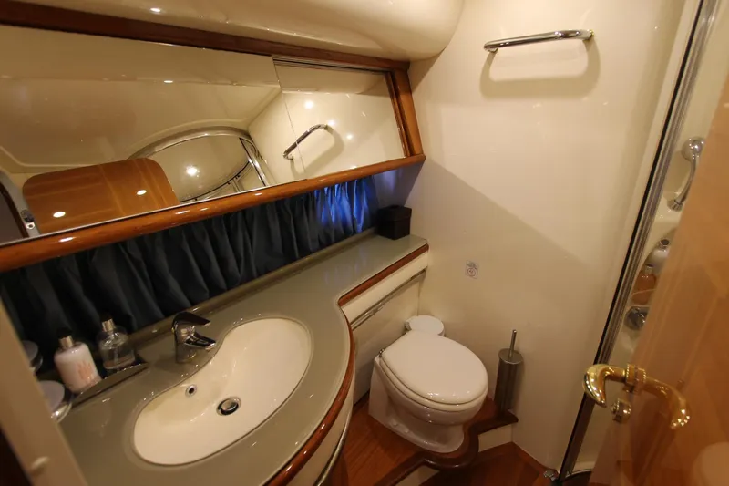 Sevrik Yacht Photos Pics Luxurious bathroom in a 2004 Azimut 62 yacht, featuring elegant fixtures and wood accents.