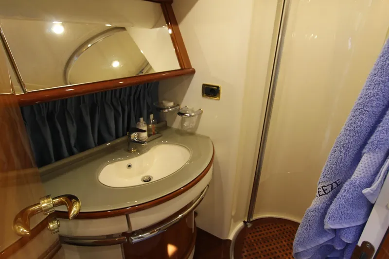 Sevrik Yacht Photos Pics Luxurious bathroom in a 2004 Azimut 62 yacht with elegant fixtures and wooden accents.
