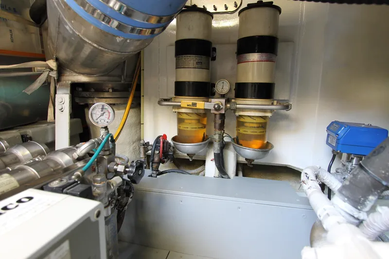 Sevrik Yacht Photos Pics Engine room of a 2004 Azimut 62 yacht, featuring fuel filters and gauges.