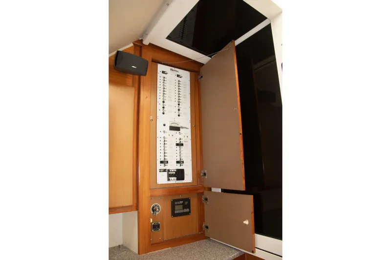 Peixe Espada Yacht Photos Pics Electrical panel inside 2013 Henriques 42 Express Hardtop boat, featuring open cabinet doors.