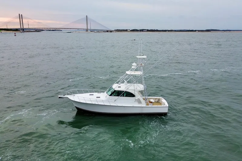 Peixe Espada Yacht Photos Pics 2016 Henriques 42 Express Hardtop boat on open water near a bridge.