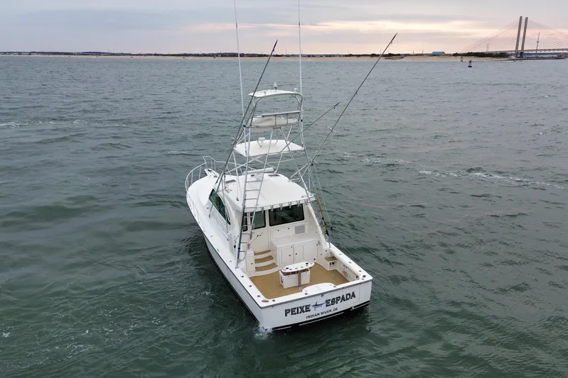 Peixe Espada Yacht Photos Pics 2016 Henriques 42 Express Hardtop boat on open water near a bridge.