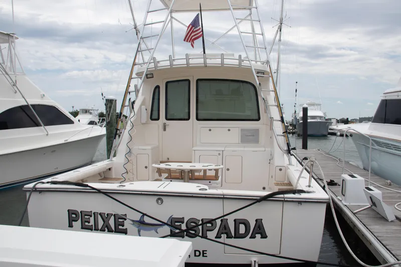 Peixe Espada Yacht Photos Pics 2016 Henriques 42 Express Hardtop docked, rear view with American flag.