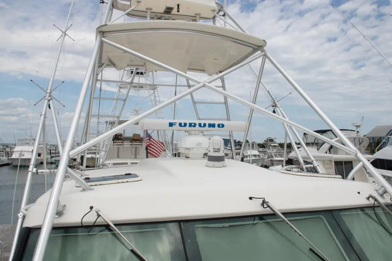 Peixe Espada Yacht Photos Pics 2016 Henriques 42 Express Hardtop boat with tower and American flag in marina.