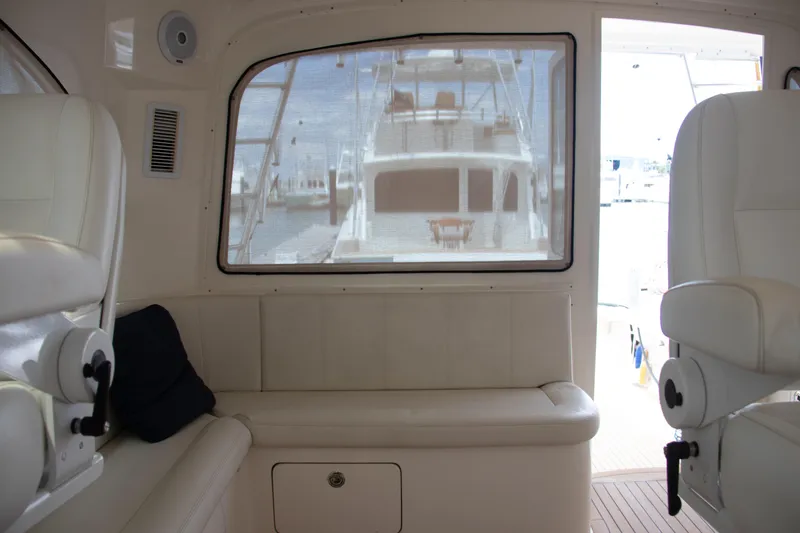 Peixe Espada Yacht Photos Pics Interior view of 2016 Henriques 42 Express Hardtop yacht with white seating and window.