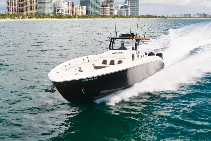  Yacht Photos Pics 2016 Midnight Express 43' Open boat cruising near city skyline.