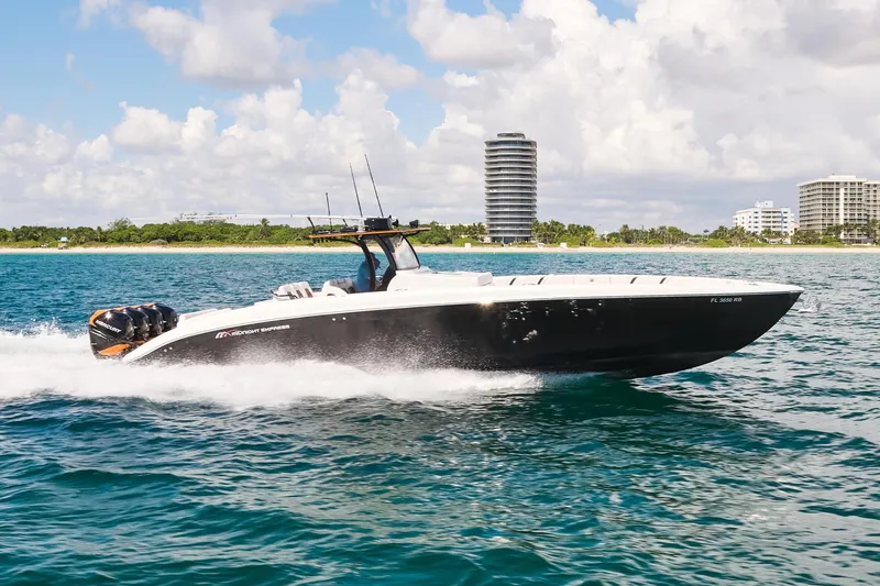  Yacht Photos Pics 2016 Midnight Express 43' Open boat cruising on the water with cityscape background.