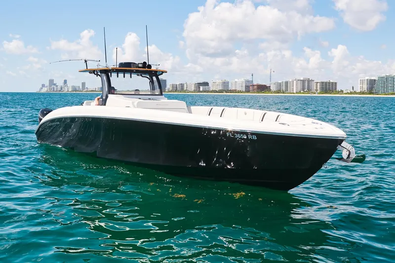  Yacht Photos Pics 2016 Midnight Express 43' Open boat on clear blue water, city skyline in background.