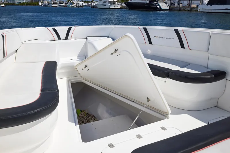  Yacht Photos Pics 2016 Midnight Express 43' Open boat with open storage compartment, docked by the water.