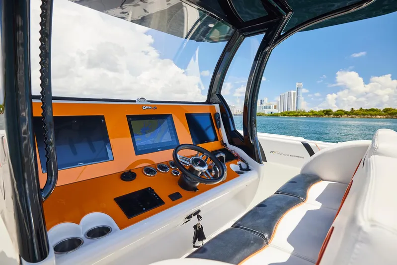  Yacht Photos Pics 2016 Midnight Express 43' Open boat dashboard with city skyline in background.