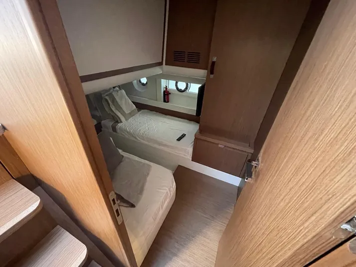 Zuma Yacht Photos Pics Cabin interior of 2021 Solaris Power 48 yacht with twin beds and wooden finish.