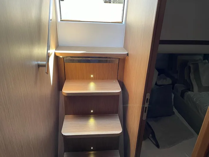 Zuma Yacht Photos Pics Staircase inside 2021 Solaris Power 48 yacht, featuring wooden steps and ambient lighting.