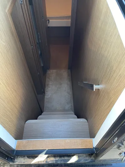 Zuma Yacht Photos Pics Interior stairs of 2021 Solaris Power 48 yacht, featuring wooden finish.