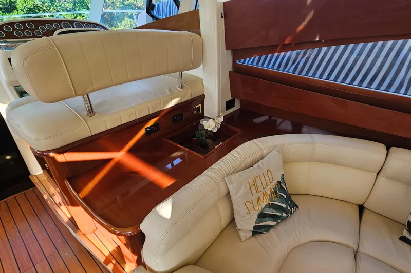 Kopara Yacht Photos Pics Luxurious interior of a 2005 Prestige 46 yacht with cream leather seating and wood accents.