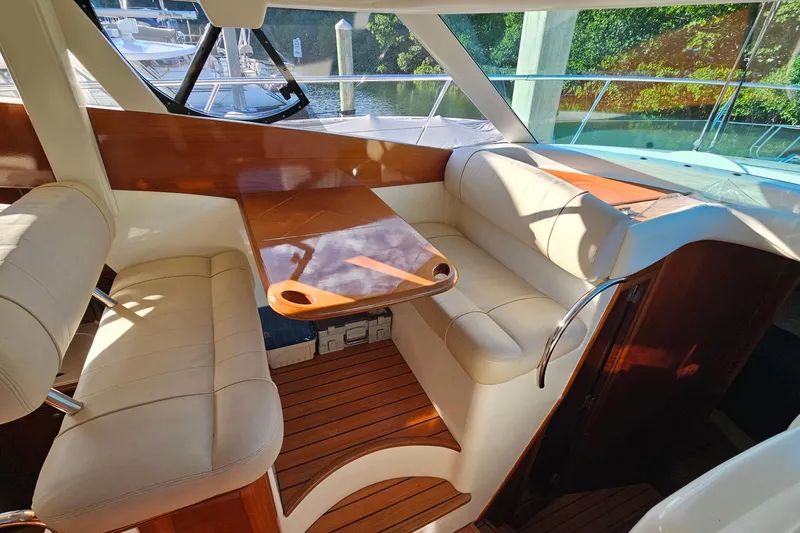 Kopara Yacht Photos Pics Luxurious interior of a 2005 Prestige 46 yacht with elegant seating and wooden accents.