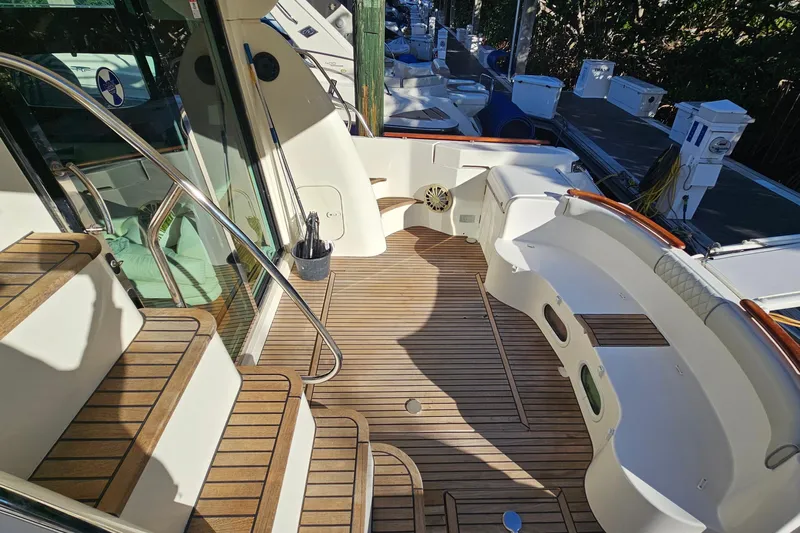 Kopara Yacht Photos Pics 2005 Prestige 46 yacht deck with wooden flooring and elegant seating area.