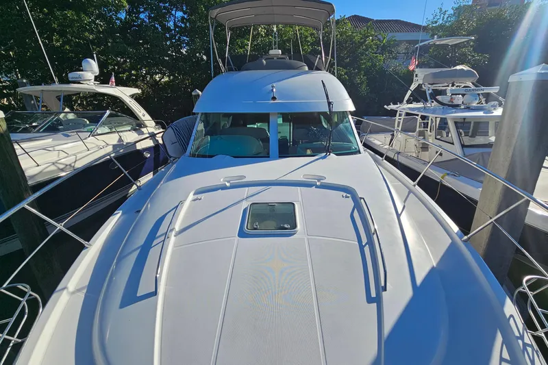 Kopara Yacht Photos Pics 2005 Prestige 46 yacht docked, surrounded by other boats, under clear blue sky.